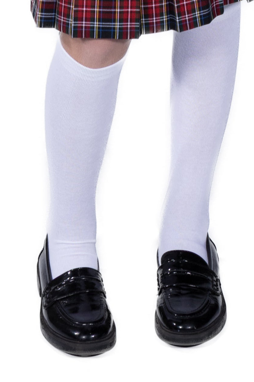 Black shoes, white socks, and a plaid skirt on a white background