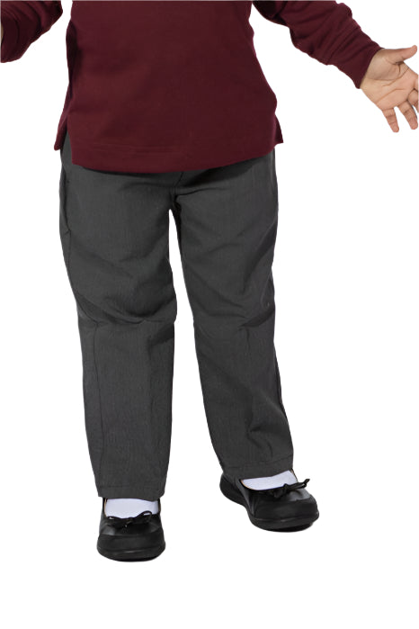 A female model wearing a white shirt and charcoal gray pants standing against a white background.
